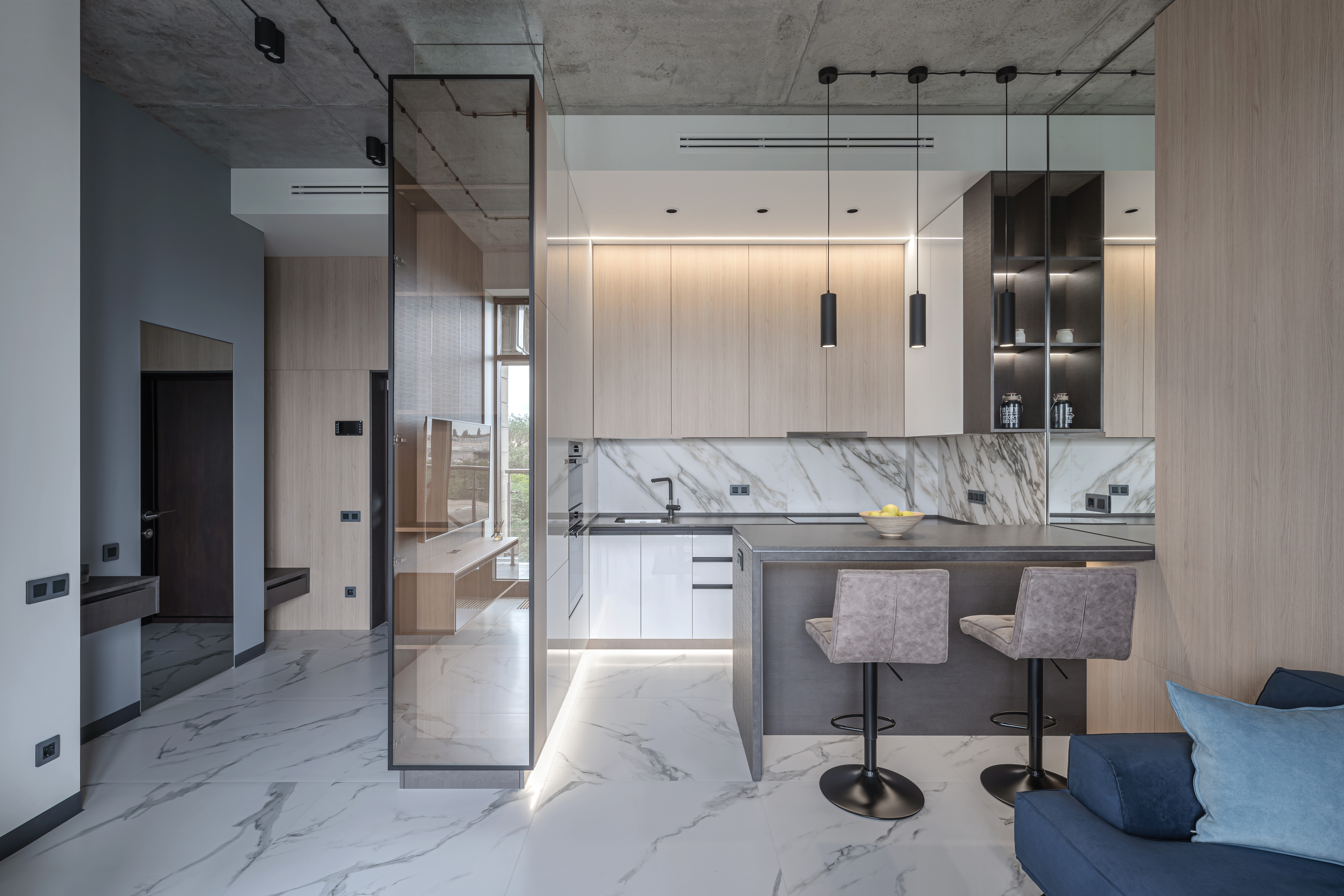 An interior where warm wood tones meet the cool elegance of marble and the raw texture of concrete.